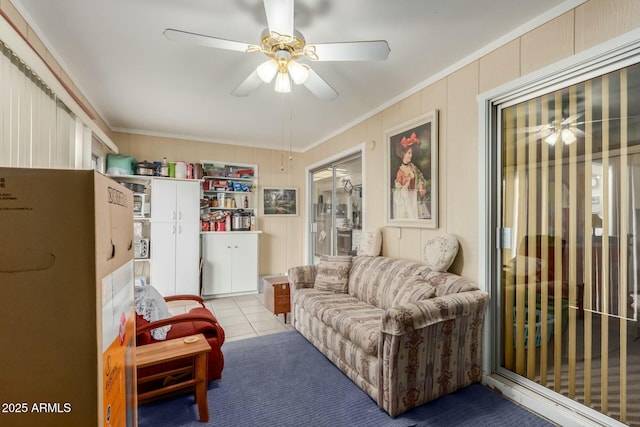 interior space with light tile patterned floors, ornamental molding, and ceiling fan