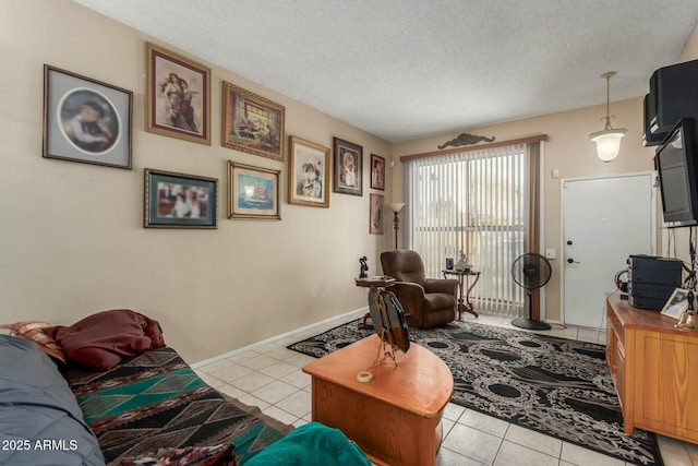 tiled living room featuring a textured ceiling