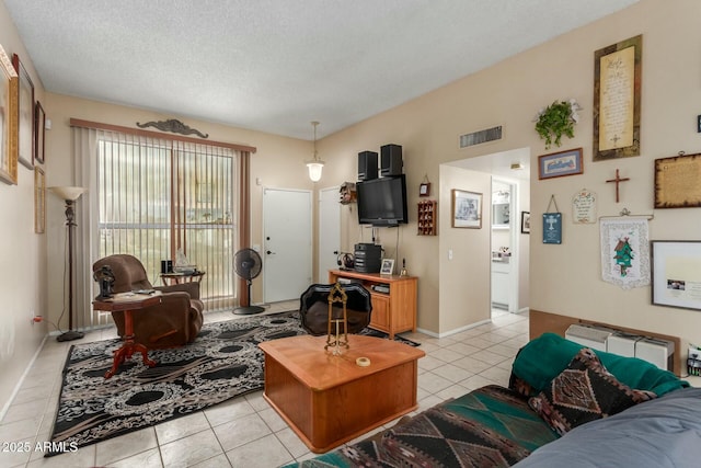 living room with light tile patterned flooring and a textured ceiling