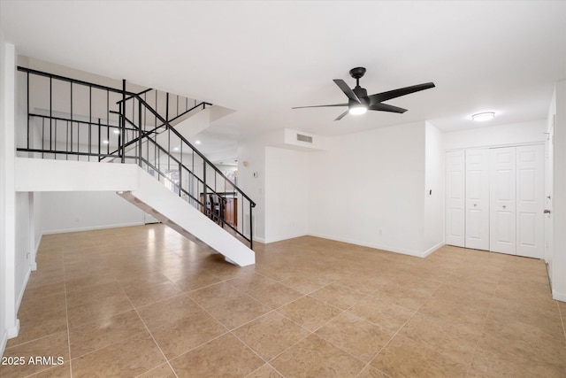 unfurnished living room featuring light tile patterned floors and ceiling fan