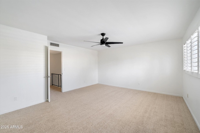 spare room featuring ceiling fan and light colored carpet