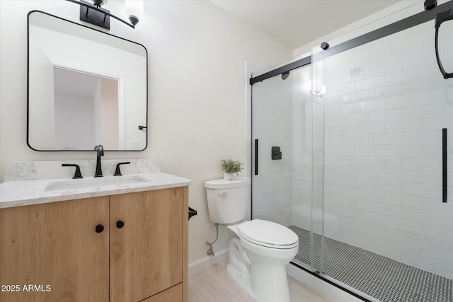 bathroom with vanity, walk in shower, and toilet