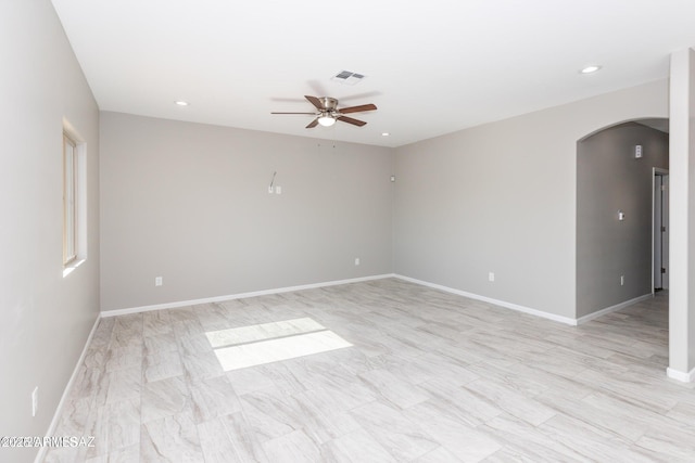 19 E Elm St, Tucson, AZ 85705 - unfurnished room with arched walkways, ceiling fan, baseboards, and recessed lighting