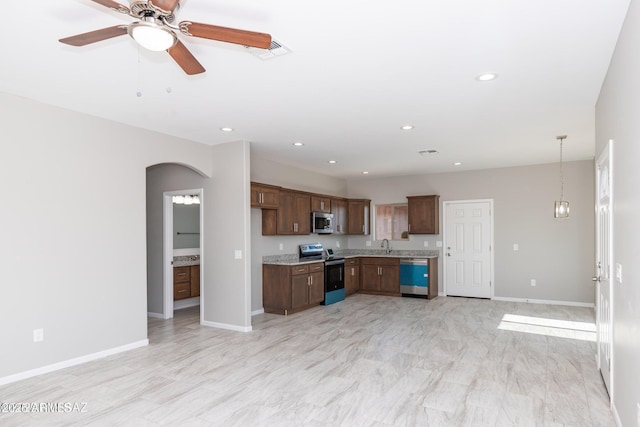 19 E Elm St, Tucson, AZ 85705 - kitchen with appliances with stainless steel finishes, light countertops, baseboards, arched walkways, and recessed lighting