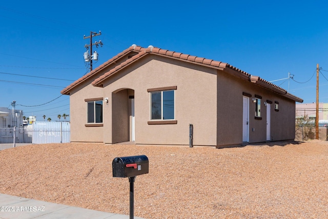 19 E Elm St, Tucson, AZ 85705 - view of front of home with a tiled roof and stucco siding