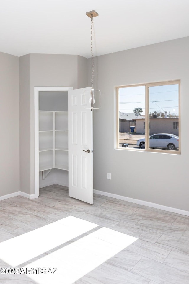 19 E Elm St, Tucson, AZ 85705 - unfurnished dining area with baseboards