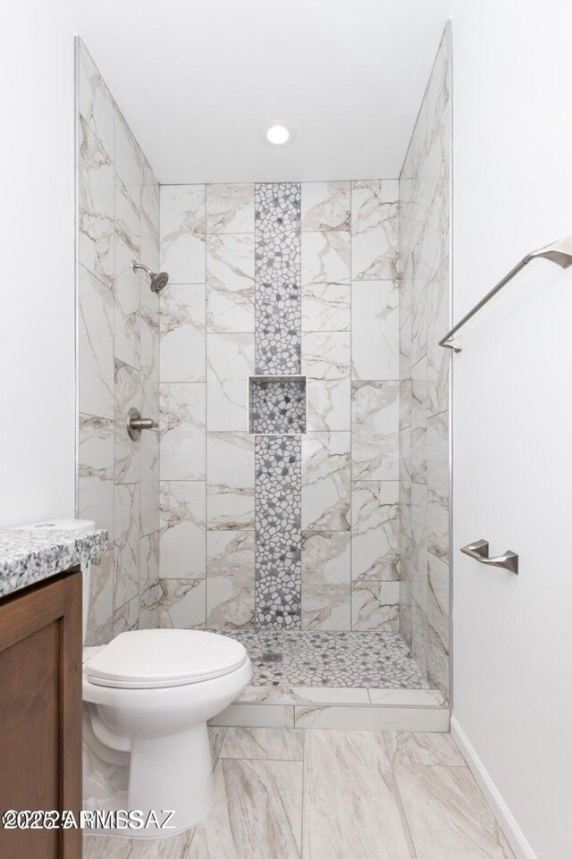 19 E Elm St, Tucson, AZ 85705 - full bathroom with a tile shower, toilet, vanity, marble finish flooring, and recessed lighting