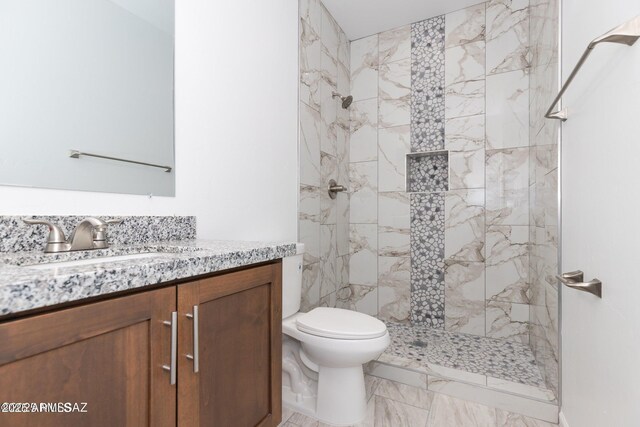 19 E Elm St, Tucson, AZ 85705 - bathroom featuring tiled shower, vanity, toilet, and marble look tiles