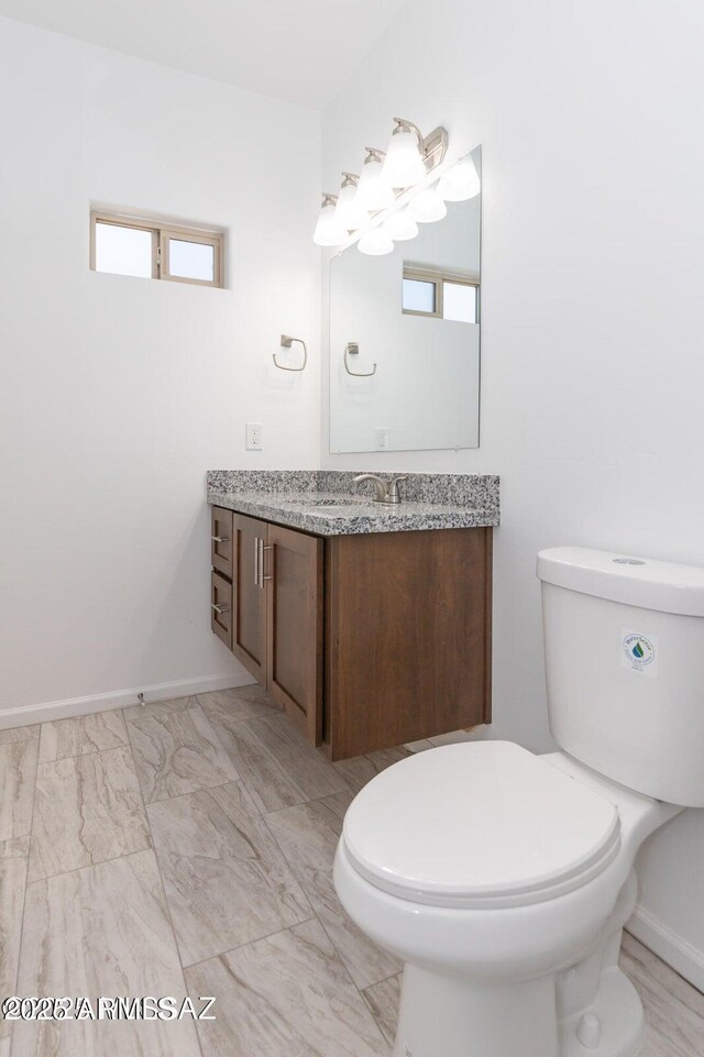 19 E Elm St, Tucson, AZ 85705 - bathroom featuring vanity, toilet, and baseboards