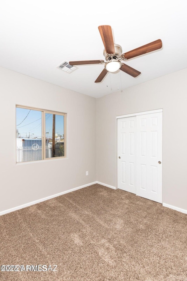 19 E Elm St, Tucson, AZ 85705 - unfurnished bedroom with carpet floors, baseboards, a closet, and ceiling fan