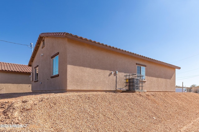 19 E Elm St, Tucson, AZ 85705 - view of property exterior featuring stucco siding and a tile roof