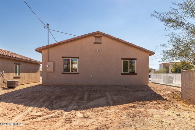 19 E Elm St, Tucson, AZ 85705 - back of house featuring cooling unit, stucco siding, and a tiled roof