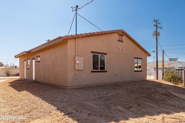 19 E Elm St, Tucson, AZ 85705 - view of home's exterior featuring a tiled roof and stucco siding