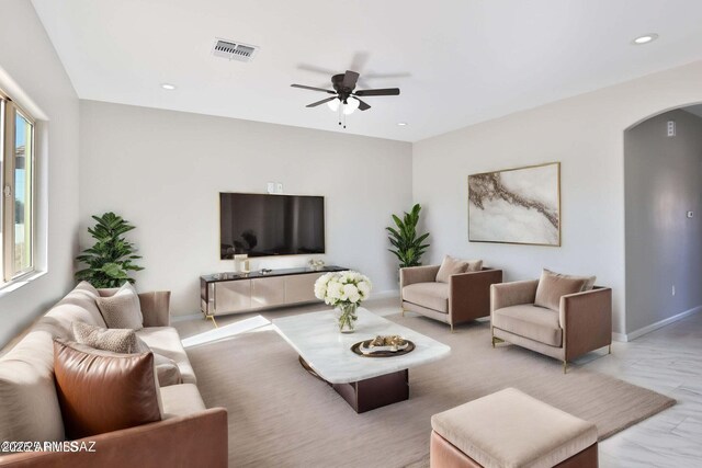 19 E Elm St, Tucson, AZ 85705 - living area featuring arched walkways, a ceiling fan, recessed lighting, light marble finish floors, and baseboards