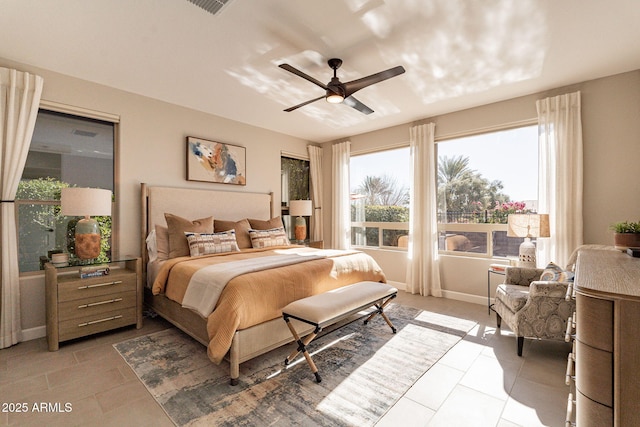 tiled bedroom featuring ceiling fan