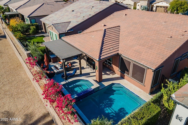 view of pool with an in ground hot tub and a patio