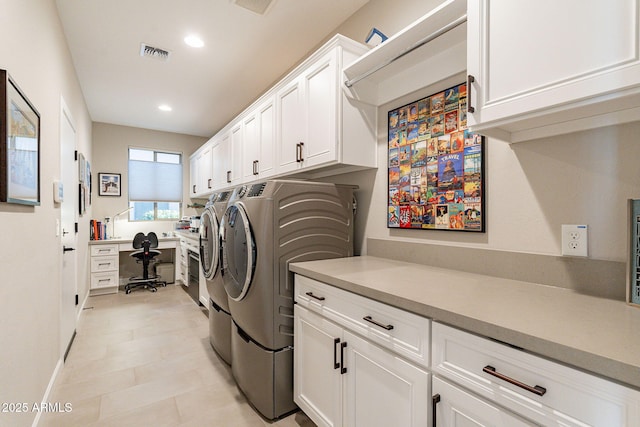 laundry room featuring cabinets and washing machine and dryer