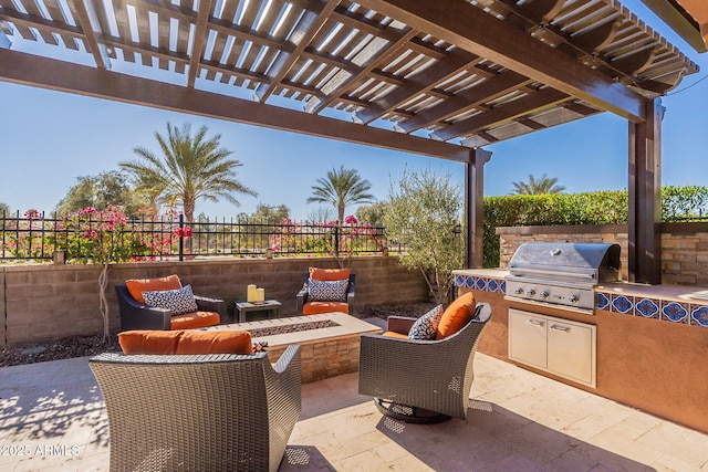 view of patio / terrace with an outdoor kitchen, a pergola, area for grilling, and a fire pit