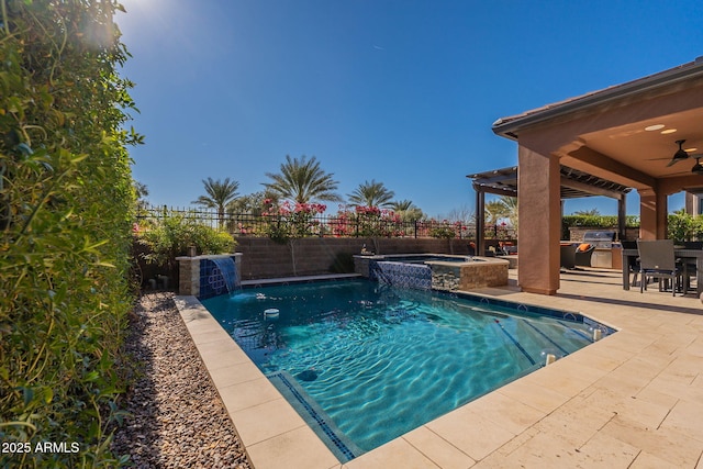 view of swimming pool with area for grilling, an in ground hot tub, pool water feature, ceiling fan, and a patio area