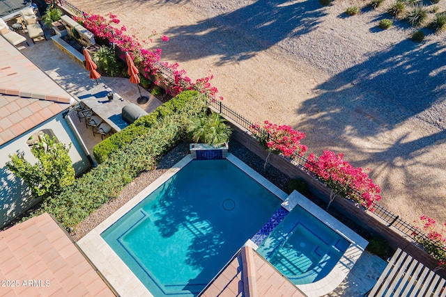 view of swimming pool featuring an in ground hot tub and a patio