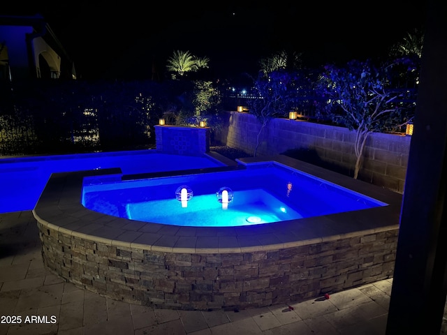 view of pool at night