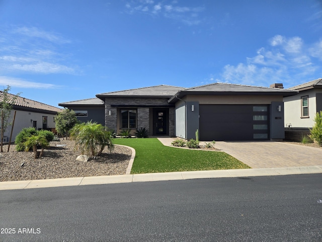 17833 E Veit Springs Dr, Rio Verde, AZ 85263 - prairie-style house featuring decorative driveway, a garage, a front lawn, and stucco siding