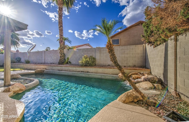 view of swimming pool featuring a fenced backyard and a fenced in pool