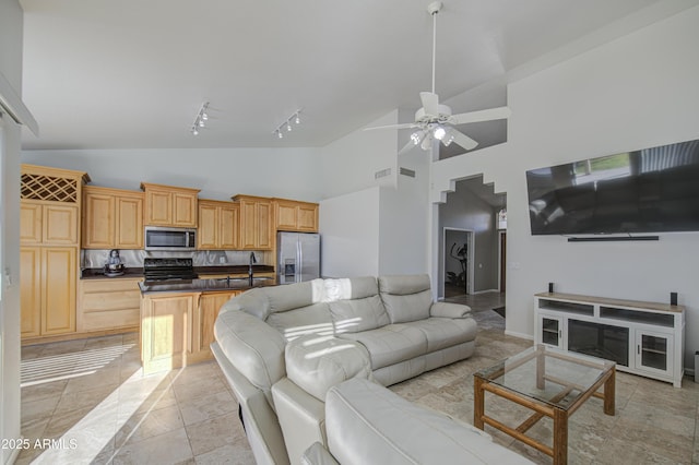 living area featuring track lighting, ceiling fan, visible vents, and high vaulted ceiling