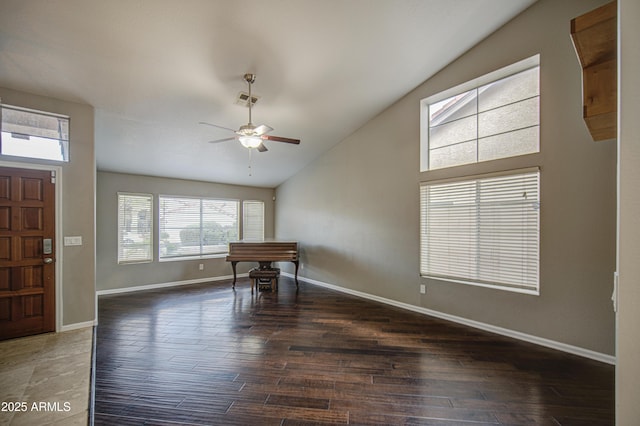 foyer entrance with plenty of natural light, a ceiling fan, and wood finished floors