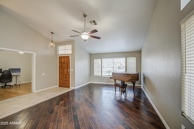 foyer entrance featuring visible vents, wood finished floors, baseboards, ceiling fan, and high vaulted ceiling