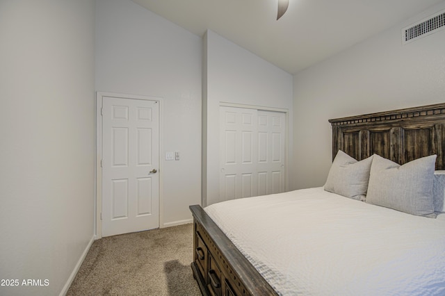 bedroom with visible vents, a closet, light carpet, baseboards, and high vaulted ceiling