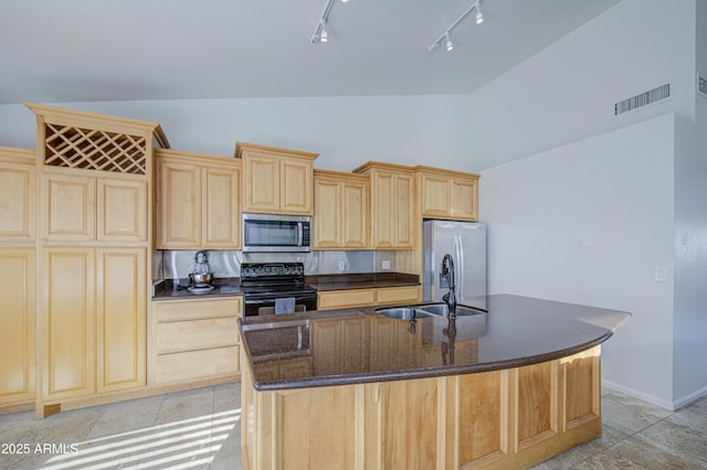 kitchen with track lighting, visible vents, light brown cabinets, a sink, and stainless steel appliances