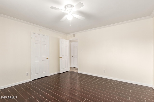 empty room featuring dark wood-type flooring, ceiling fan, and ornamental molding