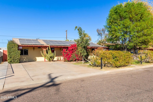 view of front of property featuring solar panels