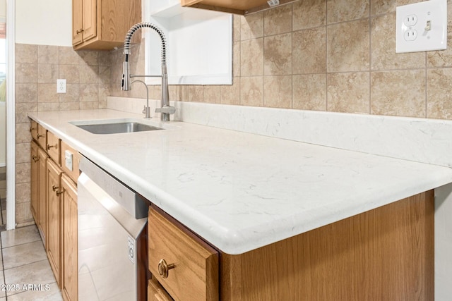 kitchen featuring light tile patterned flooring, sink, and stainless steel dishwasher