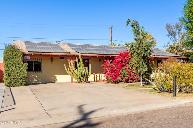 view of front of property featuring solar panels