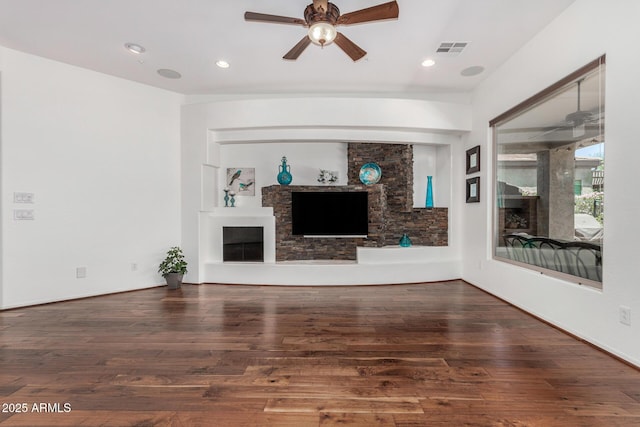 30135 N 129th Gln, Peoria, AZ 85383 - unfurnished living room featuring a ceiling fan, wood finished floors, a fireplace, and recessed lighting