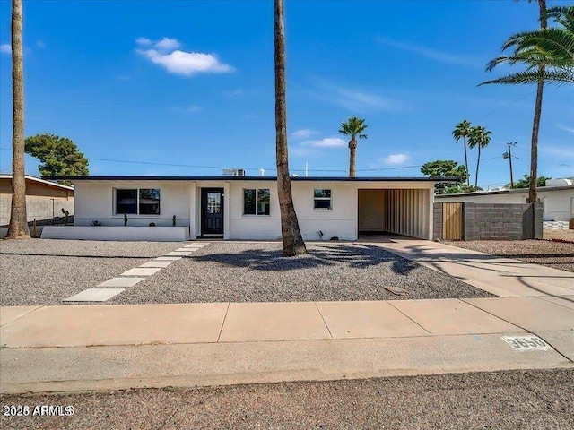 3650 E Laurel Ln, Phoenix, AZ 85028 - ranch-style house featuring concrete driveway, a carport, and stucco siding