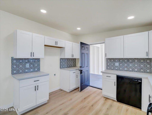 3650 E Laurel Ln, Phoenix, AZ 85028 - kitchen with black dishwasher, white cabinets, backsplash, light countertops, and recessed lighting