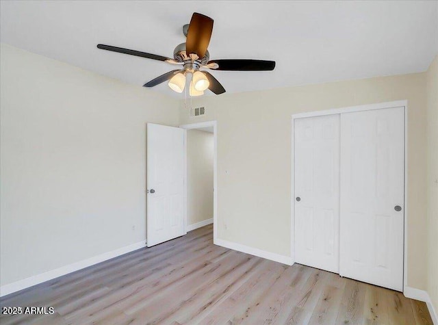 3650 E Laurel Ln, Phoenix, AZ 85028 - unfurnished bedroom with light wood finished floors, baseboards, a closet, and ceiling fan