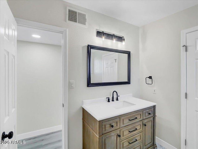 3650 E Laurel Ln, Phoenix, AZ 85028 - bathroom with vanity, baseboards, and wood finished floors