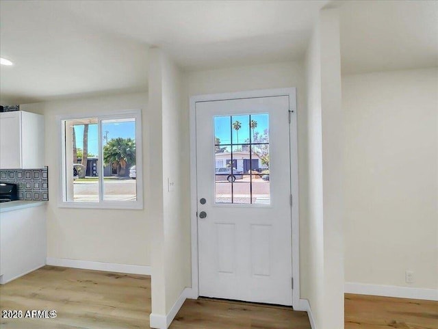 3650 E Laurel Ln, Phoenix, AZ 85028 - doorway to outside with light wood-style flooring and baseboards