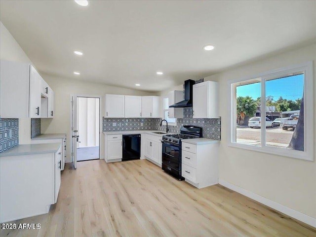 3650 E Laurel Ln, Phoenix, AZ 85028 - kitchen featuring black appliances, a sink, backsplash, wall chimney range hood, and light wood finished floors