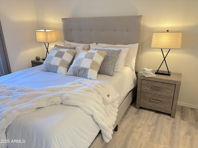 bedroom with light hardwood / wood-style floors