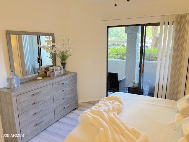 bedroom featuring access to exterior and light hardwood / wood-style flooring