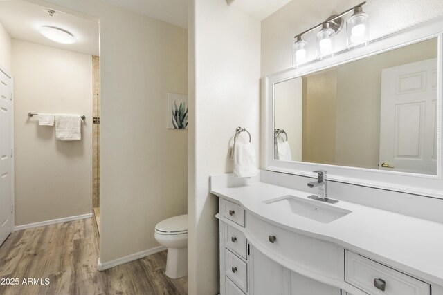 bathroom featuring vanity, toilet, and wood-type flooring