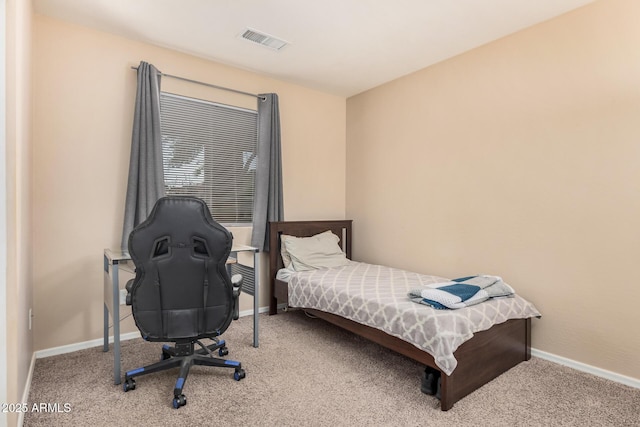 carpeted bedroom with visible vents and baseboards