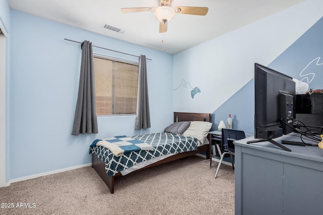 carpeted bedroom featuring a ceiling fan, visible vents, and baseboards