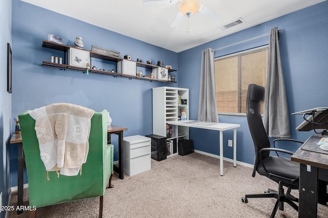 carpeted home office featuring ceiling fan, visible vents, and baseboards