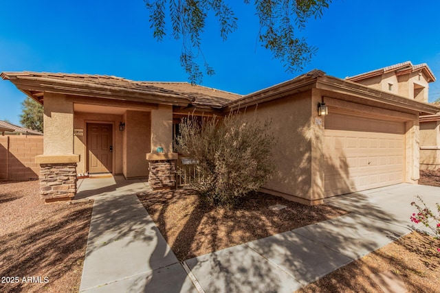 view of front of property with a garage, driveway, fence, and stucco siding